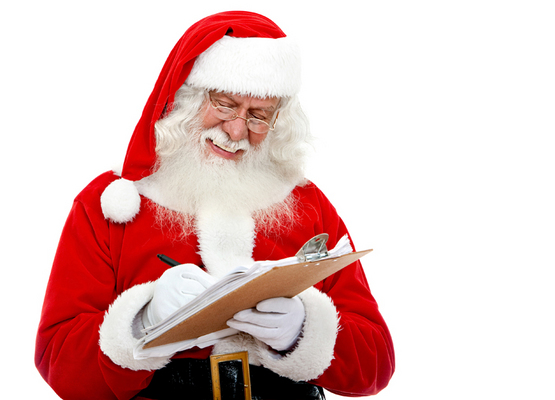 Christmas portrait of Santa Claus writing a list isolated over a white background